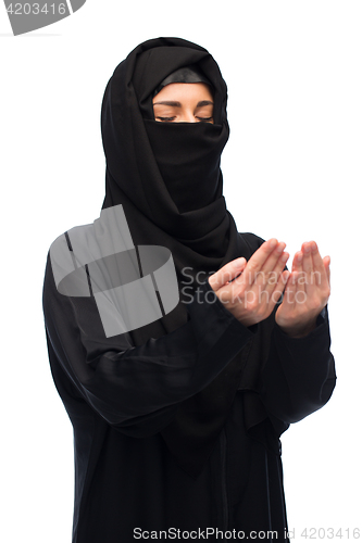 Image of praying muslim woman in hijab over white