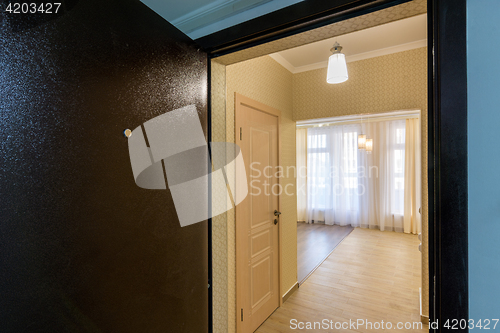 Image of Renovated apartment in new building, view from the open front door