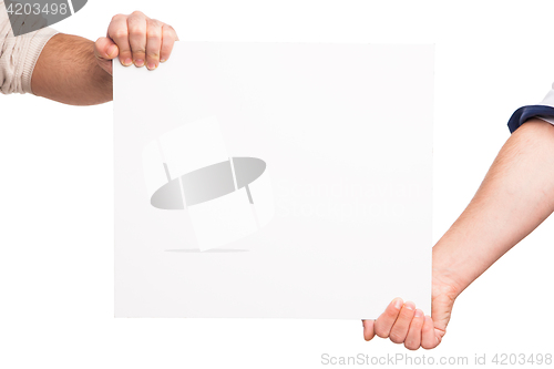 Image of Hands holding a blank white board