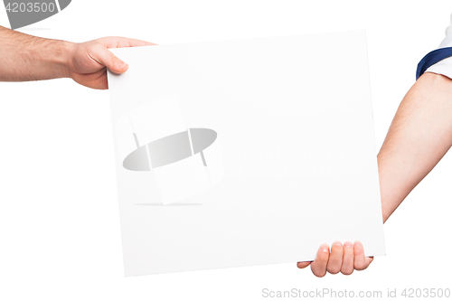 Image of Hands holding a blank white board