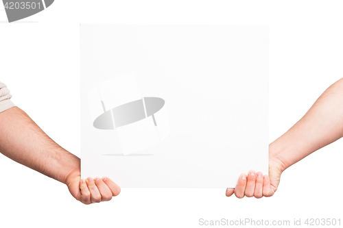 Image of Hands holding a blank white board