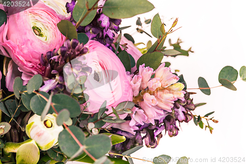 Image of Ranunkulyus bouquet of red flowers on a white background