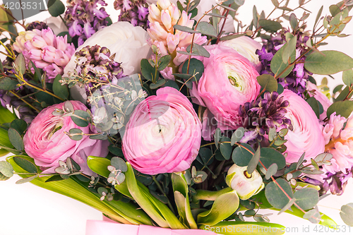 Image of Ranunkulyus bouquet of red flowers on a white background