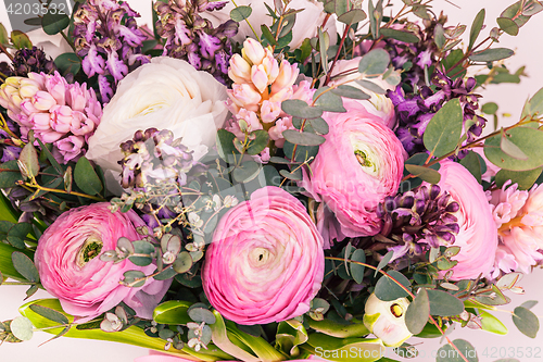 Image of Ranunkulyus bouquet of red flowers on a white background