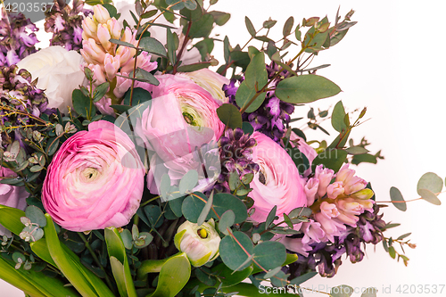 Image of Ranunkulyus bouquet of red flowers on a white background