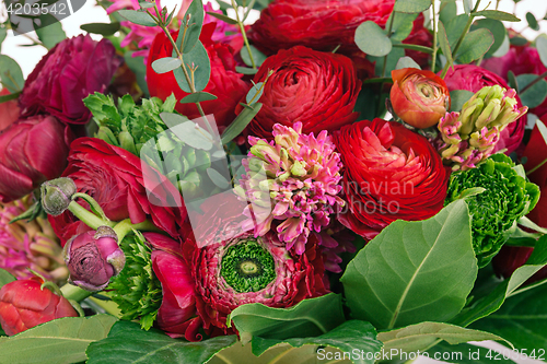 Image of Ranunkulyus bouquet of red flowers on a white background