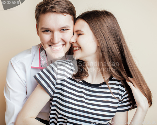 Image of couple of happy smiling teenagers students, warm colors having a kiss, lifestyle people concept, boy and girl together 