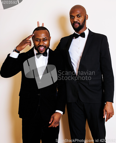 Image of two afro-american businessmen in black suits emotional posing, g