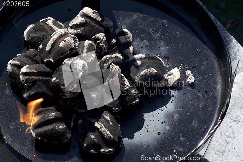 Image of charcoal briquettes in small bbq