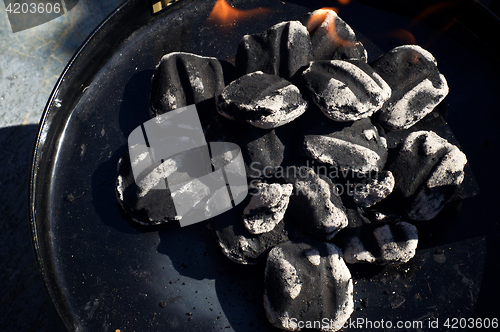 Image of close up of charcoal briquettes with flames