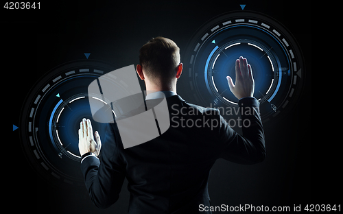 Image of businessman touching virtual screen