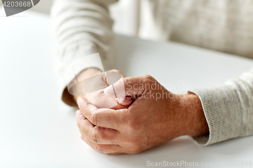 Image of close up of senior man hands on table