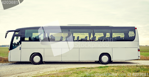 Image of tour bus driving outdoors