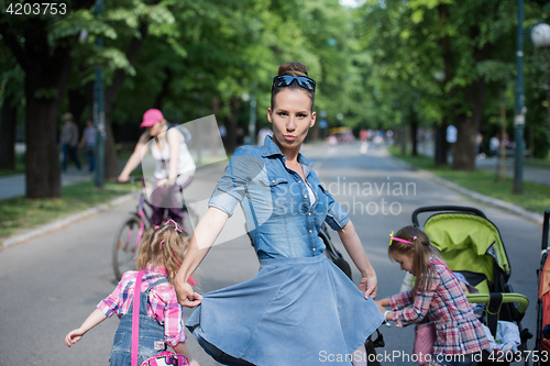 Image of mother with her daughters in the park