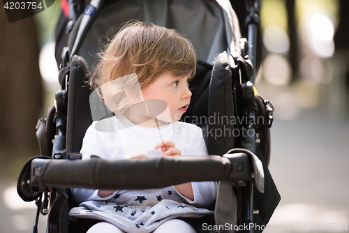 Image of baby girl sitting in the pram