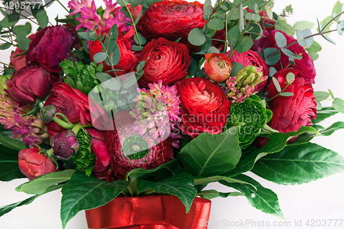 Image of Ranunkulyus bouquet of red flowers on a white background