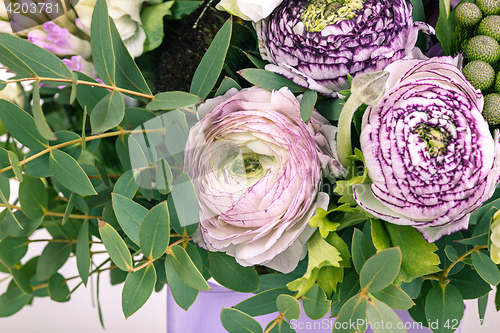 Image of Ranunkulyus bouquet of red flowers on a white background