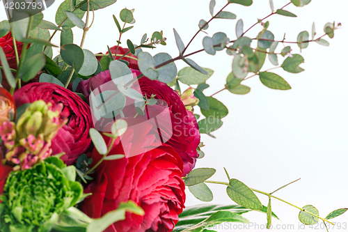 Image of Ranunkulyus bouquet of red flowers on a white background