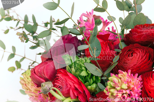 Image of Ranunkulyus bouquet of red flowers on a white background