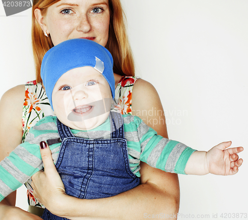 Image of young beauty mother with cute baby, red head happy modern family