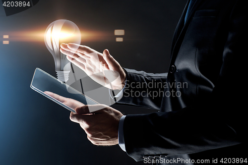 Image of close up of businessman with transparent tablet pc