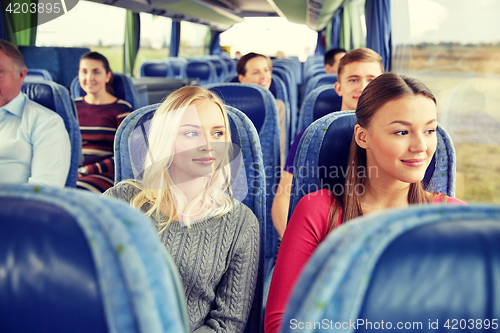Image of happy young women riding in travel bus