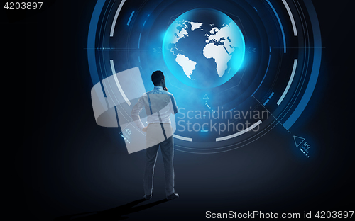 Image of businessman looking at virtual earth projection