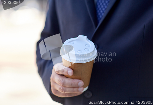 Image of senior businessman with coffee cup outdoors