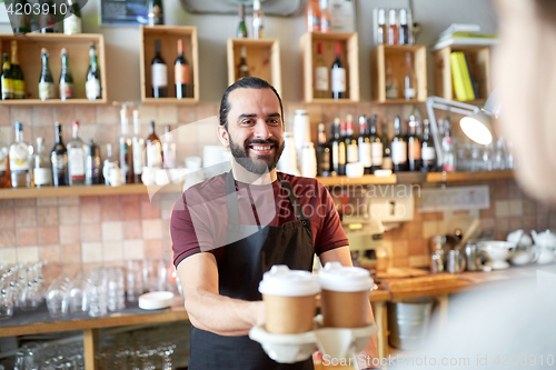 Image of man or waiter serving customer in coffee shop