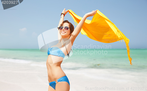 Image of woman in bikini and sunglasses with pareo on beach