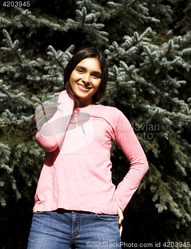 Image of Enjoying the nature. Young woman enjoying the fresh air in green