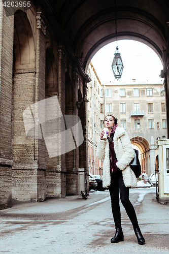 Image of young pretty stylish teenage girl outside on city street fancy f