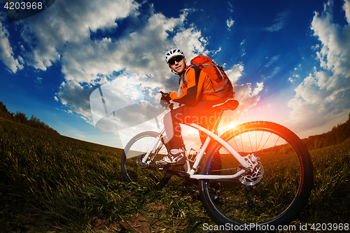 Image of cyclist riding bike on a nature trail in the mountains.