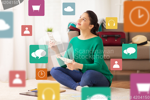 Image of happy woman with money and travel map at home