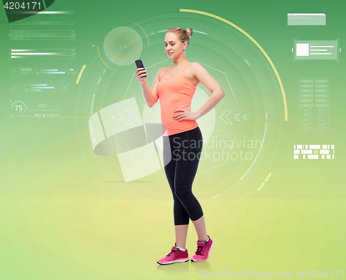 Image of happy smiling sportive young woman with smartphone