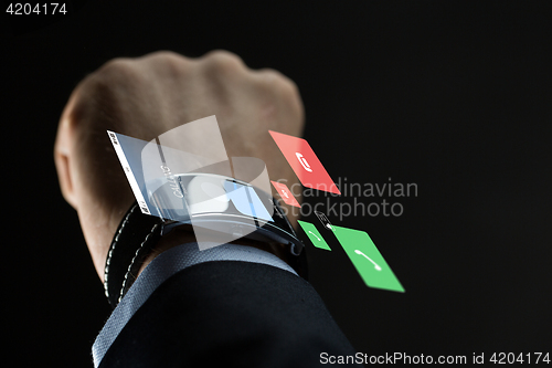 Image of close up of businessman hand with smartwatch