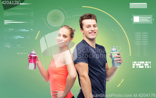 Image of sportive man and woman with water bottles