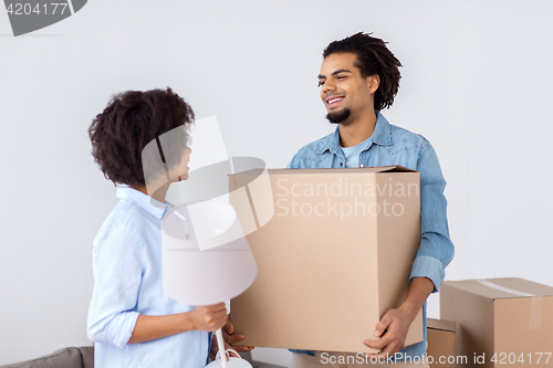 Image of happy couple with stuff moving to new home