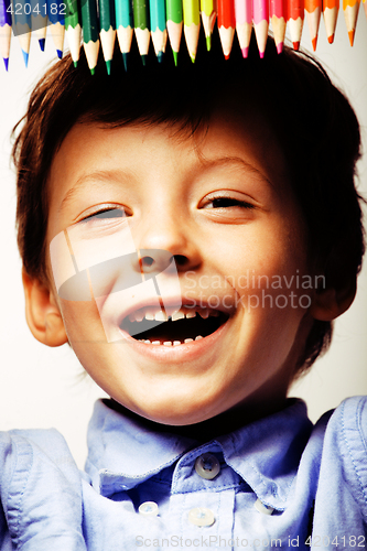 Image of little cute boy with color pencils close up smiling, education f