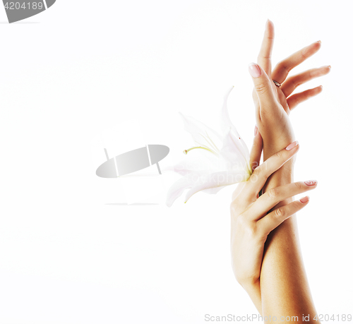 Image of beauty delicate hands with manicure holding flower lily close up