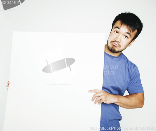 Image of pretty cool asian man holding empty white plate smiling