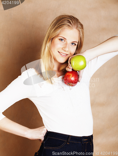 Image of young blond woman with green and red apple, good choice, diet concept 