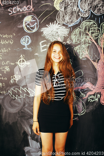 Image of portrait of happy cute student in classroom at blackboard back to school having fun, girl at college