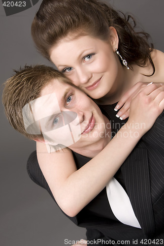 Image of Portrait of a young beautiful couple embracing.