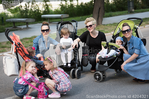 Image of mother with children in the park