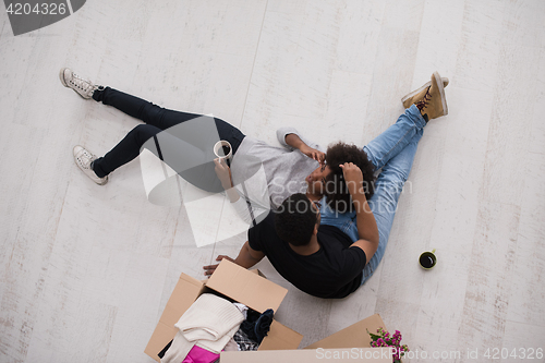 Image of African American couple relaxing in new house