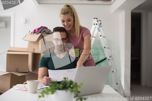 Image of Young couple moving in a new home