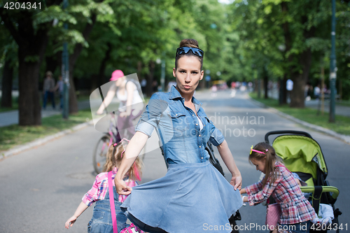 Image of mother with her daughters in the park