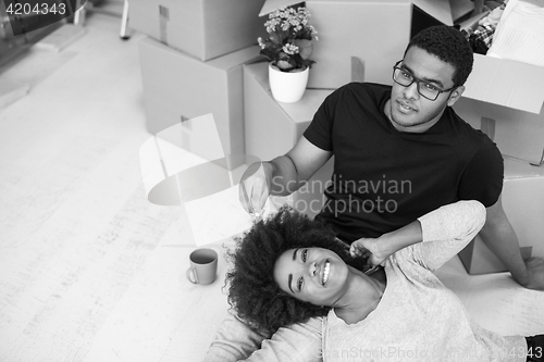 Image of African American couple relaxing in new house