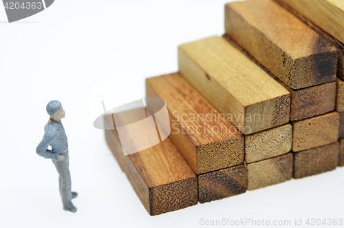 Image of Way to success with  businessman and wood block step